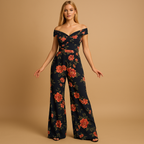 Women’s floral off-shoulder jumpsuit with tailored fit and colorful print. Ideal outfit for weddings, summer parties, and elegant events.