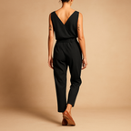 Women’s V-neck belted jumpsuit with adjustable waistband and long legs, available in dark blue, caramel, and black for summer and casual wear.